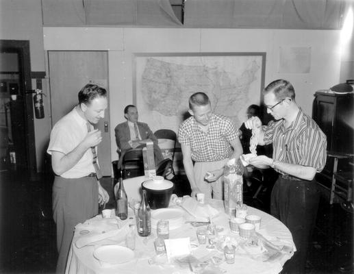 Students & press around a table