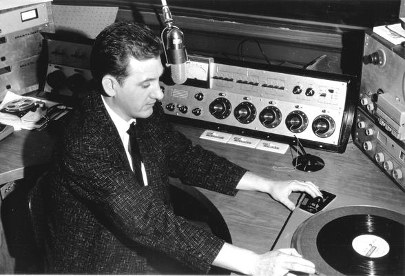 Man at studio turntable getting ready to play Dinah Shore album