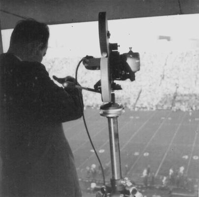 Ric Sanderson next to camera during football game at Stoll Field