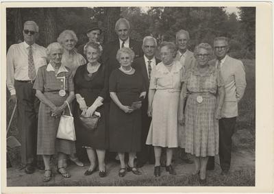 Group of seven women and five men standing on a lawn (August 13, 1961). On the right is Former Students Association historian, Mrs. Pearl Day Bach