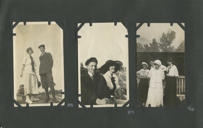 a woman and man standing on a small mound; a man and woman (appears to be the same man as in item #88) sitting together; 3 women and a man standing in front of a fence outside