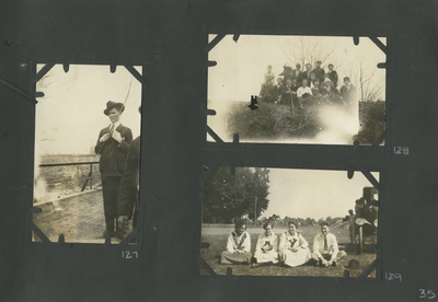 a man standing on what appears to be a bridge holding a stick; a group of men and women sitting outside; 3 women and a man sitting on the ground next to a car