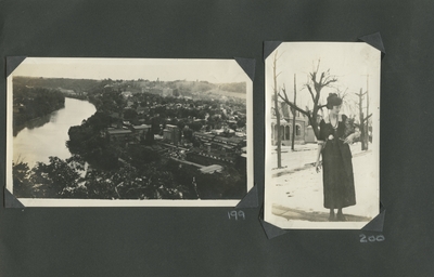 view of a city; a woman (appears to be the same woman as image #197) holding a small animal outside