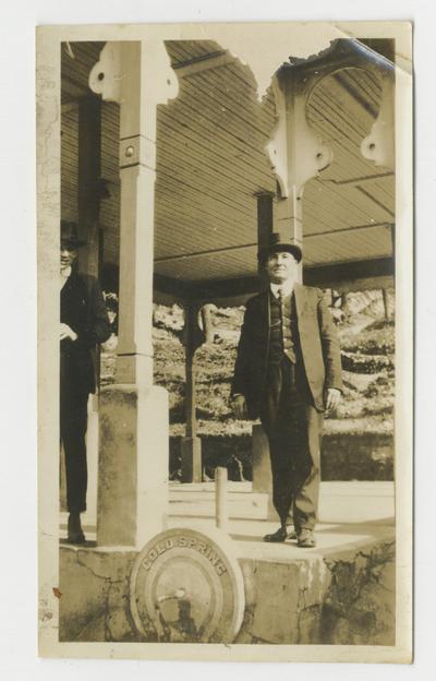 Two unidentified men standing on a gazebo