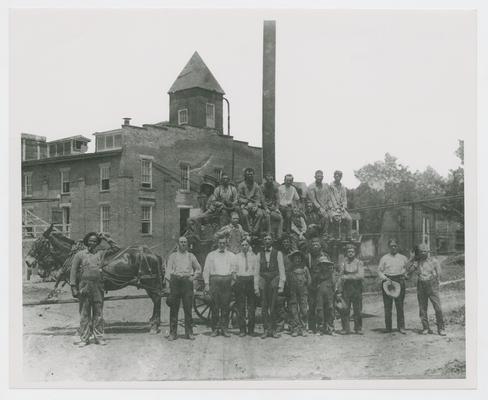 Group of men and two boys posing with mule and wagon