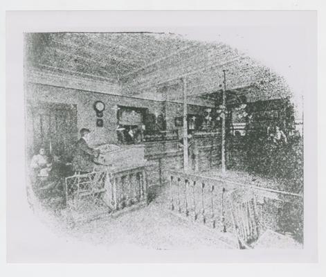 Man at desk in office, photographic reproduction