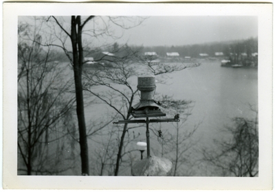 View of a lake with a bell in the foreground