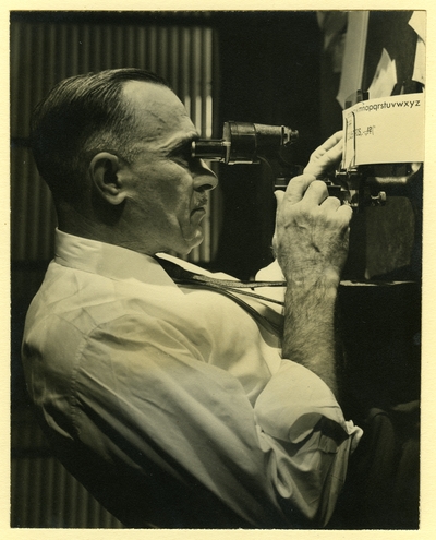 Chauncey Hawley Griffith looking through an eyepiece
