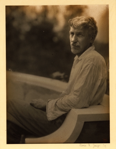 Charles R. Lamb;  Bearded man with mustache, in shirt and pants, seated on bench