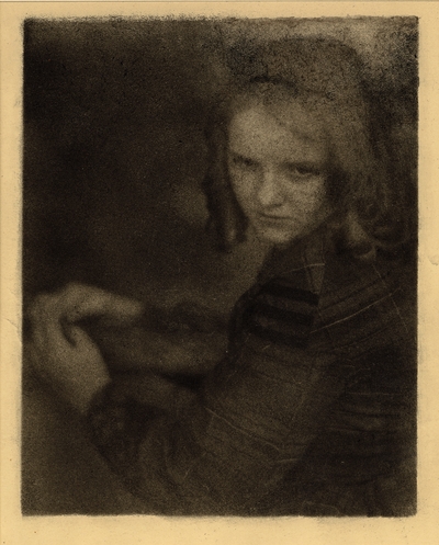 Close-up of girl in ringlets and dress, looking over shoulder, hands together