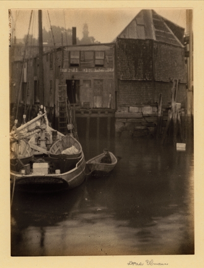 Gloucester, MA.  Boats with wharf and old buildings in background