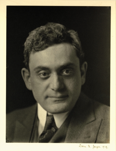 Head shot of man in coat and tie