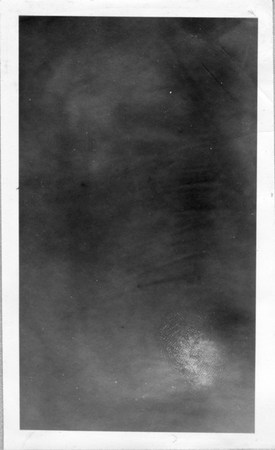 Black-and white photograph [mentioned in Item 3a]. Illegible                                 in normal light