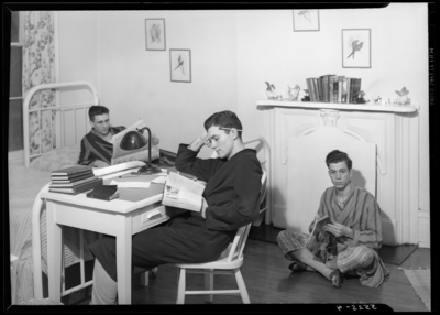 Georgetown College; dorm room; interior; three men                             reading