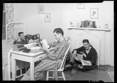 Georgetown College; dorm room; interior; three men                             reading