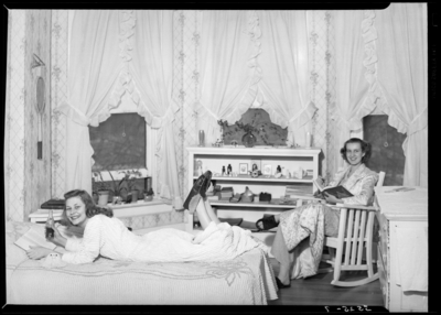 Georgetown College; dorm room; interior; woman lounging on bed;                             woman sitting in rocking chair