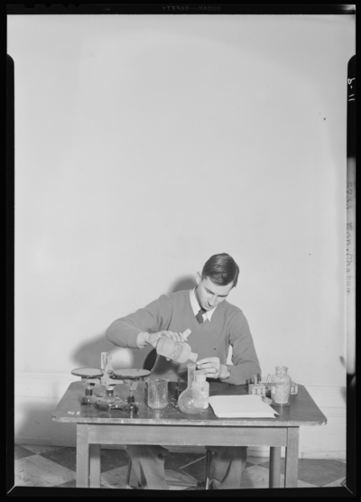 Georgetown College; Don Chatam sitting at desk mixing                             chemicals