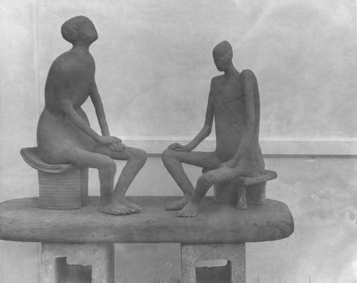 Two ceramic sculptures by John Tuska. Both sculptures are of human figures sitting on stools