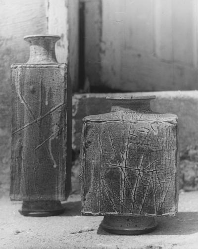 Two ceramic pots by John Tuska. Both pots have rectangular bodies, and one is taller than the other