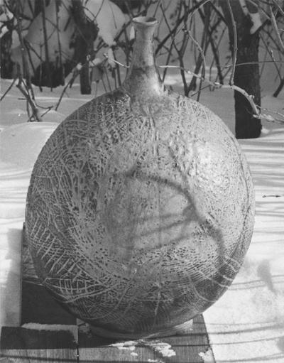 A ceramic vase sitting in the snow, a piece of John Tuska's Alfred University graduate work