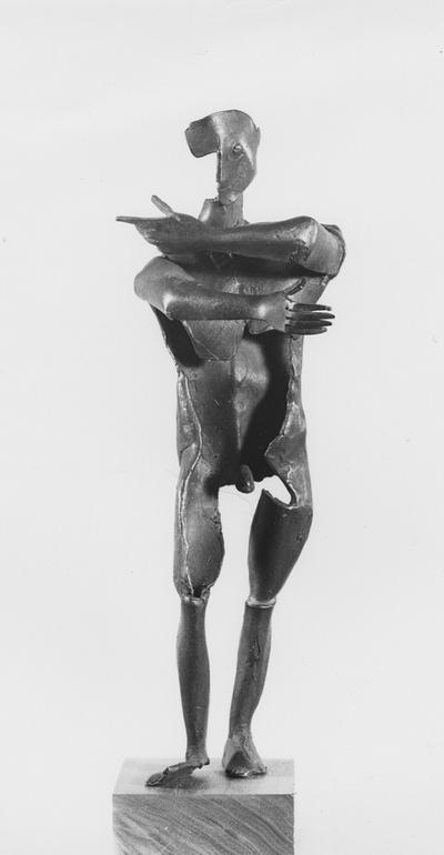 A bronze male nude sculpture with a walnut base entitled 