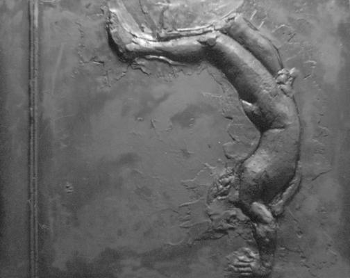 A fiberglass relief sculpture of a male nude falling by John Tuska. This piece is a part of Tuska's 