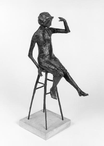 A bronze sculpture of a female nude mounted on travertine marble entitled 