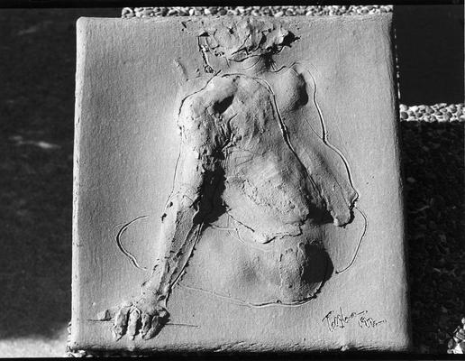 A ceramic tile relief of a male nude by John Tuska