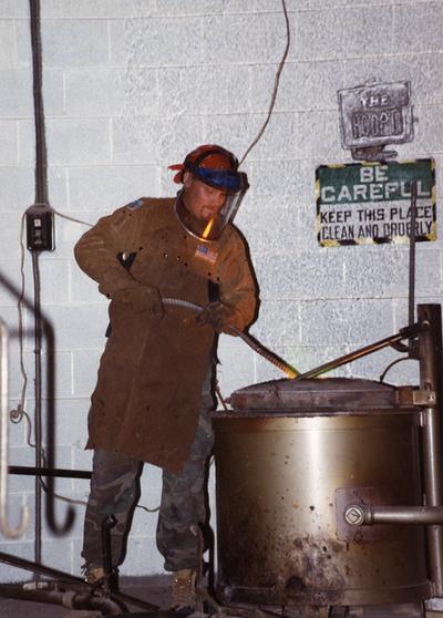 Scott Oberlink checking the furnace for the casting of 