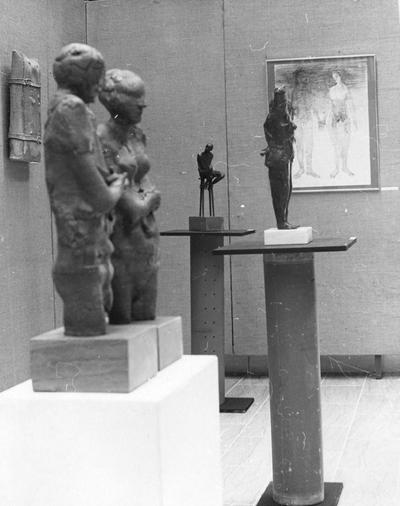 Three sculptures, a ceramic vessel and one ink drawing at an exhibit in the Spindletop Research Center