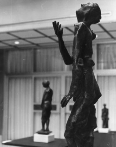 Three bronze figure sculptures at an exhibit in the Spindletop Research Center