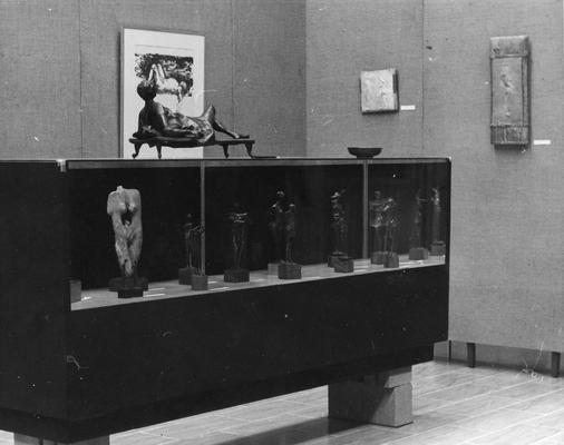 A case of sculptures with a bronze figure sculpture entitled 