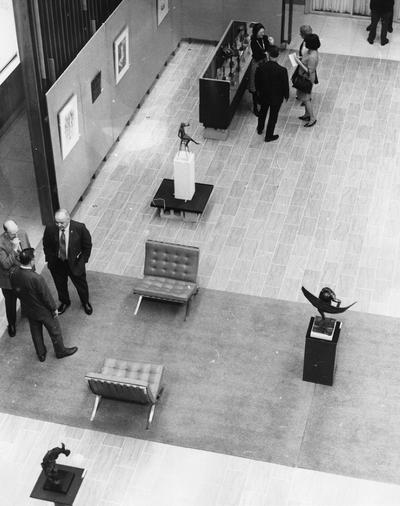 Two groups of people viewing the exhibit at the Spindletop Research Center