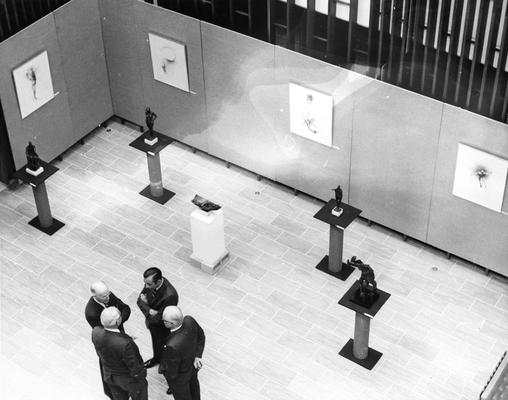 A group of people talking in the exhibit space at the Spindletop Research Center