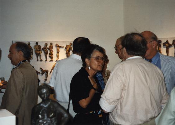 A image of John Tuska and unidentified persons viewing artwork at the Heike Pickett Gallery