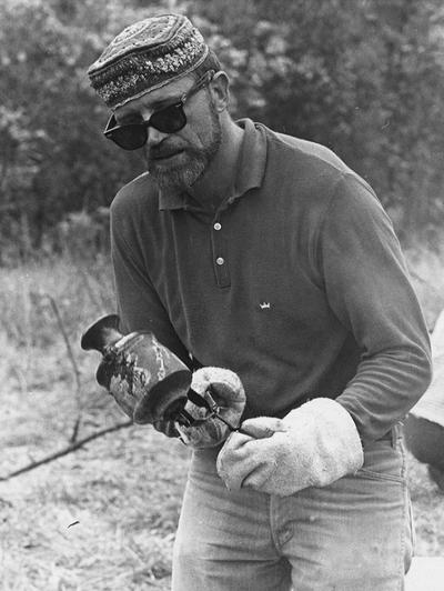 John Tuska examining a clay vessel after a raku firing