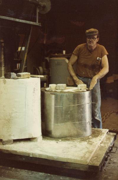 John Tuska preparing molds for a foundry class at the University of Kentucky. The photograph was taken by Ted Bronda