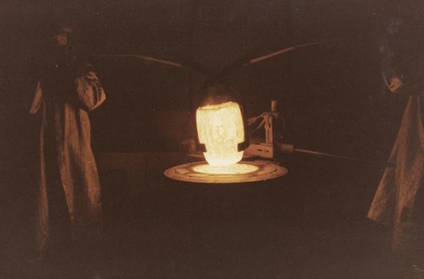 John Tuska and Jack Gron lifting a crucible out of a furnace at the University of Kentucky foundry. The photograph was taken by Ted Bronda